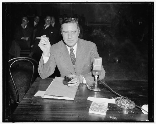 NLRB Invesitgating Committee quizzes Edwin Smith?, NLRB Board member. Washington, D.C., Dec. 15. Edwin S. Smith, member of the National Labor Relations Board photographed as he testified before the Smith Committee investigating the NLRB