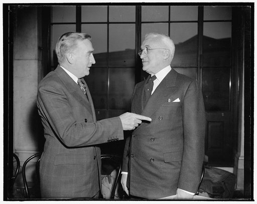 Snapped at Monopoly hearing. Washington, D.C., Dec. 20. Senator Joseph C. O'Mahoney, left, co-chairman of the National Monopoly Committee, chats with H.S. Stuart, of Halsey, Stuart & Co., just before today's session of the hearings got under [...