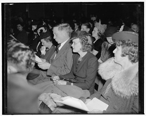 Picture of a Supreme Court Justice whistling 'Jingle Bells.' Washington, D.C., Dec. 20. During the 8th Annual broadcasting of the Children of Diplomats stationed here in Washington, Supreme Court Justice William O. Douglas, and his wife, sat with other mothers and fathers watching their offspring sa