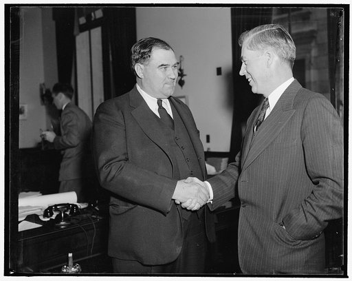 Wallace greets new Assistant Secretary of Agriculture. Washington, D.C., Dec. 21. Secretary Henry A. Wallace congratulates Grover B. Hill of Gainesville, Texas, after he assumed his new post as Assistant Secretary of Agriculture today. Hill, formerly with the Tennessee Valley Authority, succeeds Har