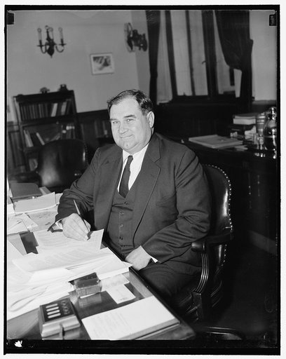New Assistant Secretary of Agriculture. Washington, D.C., Dec. 21. Grover B. Hill of Gainesville, Texas, who was today sworn in as Assistant Secretary of Agriculture, photographed at his desk shortly after the ceremony. Hill, who was formerly with the Tennessee Valley Authority, succeeds Harry L. Br