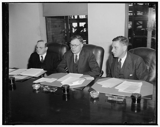 National Labor Relations Board. Washington, D.C., Dec. 22. The National Labor Relations Board, now being investigated by a Special House Committee, were snapped in this new informal picture during a hearing today. Left to right: William M. Leiserson, J. Warren Madden, Chairman, and Edwin S. Smith