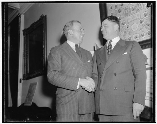 Hanes greets successor as Undersecretary of Treasury. Washington, D.C., Dec. 30. John W. Hanes, left, who resigns his post as Undersecretary of Treasury Jan. 1 to reenter private business, greets his successor Daniel W. Bell, now acting Director of the budget. Bell has been a career civil service ma