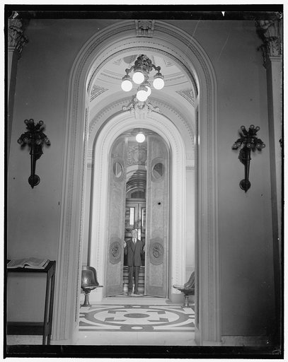 House doors ready for Congressional opening. Washington, D.C., Jan. 2. Joseph J. Sinnott, doorkeeper of the House of Representatives, makes a final inspection of the huge doors leading to the House Chamber to be sure there will be no hitch in their opening when the third session of the 76th Congress