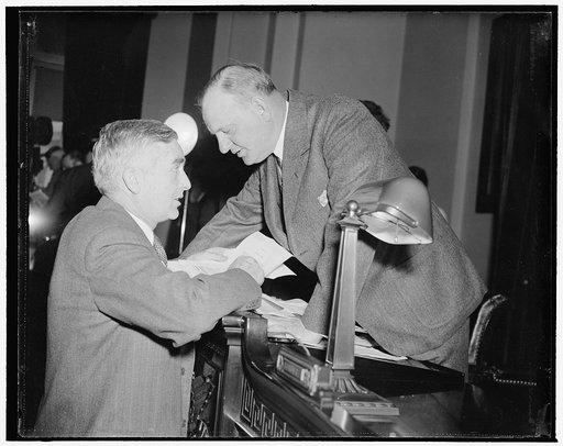 Navy Secretary and Naval Affairs Committee Chairman chat at meeting. Washington, D.C., Jan. 8. At the meeting of the House Naval Affairs Committee today, Secretary of the Navy Charles Edison was photographed chatting with Chairman Carl Vinson. Left to right: Edison and Vinson