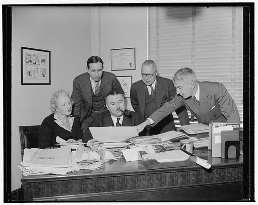 Franklyn Waltman at desk with group