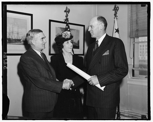 After taking oath as Asst. Secy. of the Navy, Lewis Compton, left, is congratulated by Mrs. Compton, and the Secy. of the Navy, Charles Edison, Feb. 9, 1940