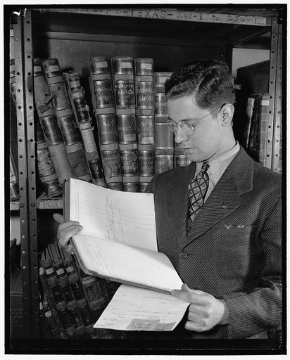 Man standing in front of book shelves which hold volumes related to the 11th US Census of 1890 at the US Census Bureau