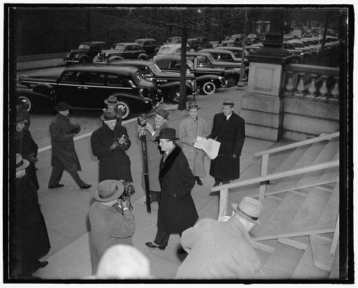 Finnish minister discusses Russo-Finnish peace statement with Secretary Hull. Washignton, D.C., March 13. Finnish Minister Hjalmar J. Procope, center, runs a gauntlet of news photographers and reporters as he leaves State Department following a meeting with Secretary Hull at which he was shown a cop