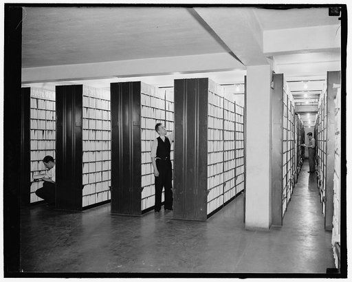 Patent official, patent record files. Files of patents of which 2,180,00 have been issued. These files extend over 50 miles in total length and are kept in air conditioned portion of the building, washed air keeps paper from iridizing. Another old patent of drawing without the specification. This de