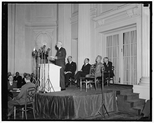 Cordell Hull at podium; Sumner Welles and others on platform