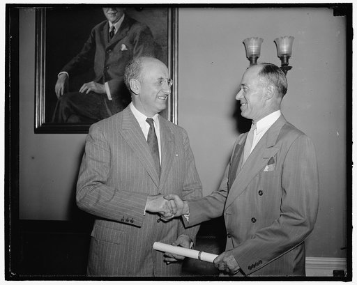 Admiral Waesche sworn in for another four years. Washington, D.C., June 13. Today at the Office of the Secretary of the Treasury, Admiral Russell Randolph Waesche, was reappointed for another four years to the office of Commandant of the Coast Guard. Seen in the picture is Secretary of the Treasury 