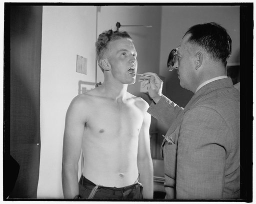 New recruits join up, Washington, D.C. Kemit Kuhn, 21 years old, of Bayard, West Virginia, being examined by army doctor Major Seth Gayle, Jr.
