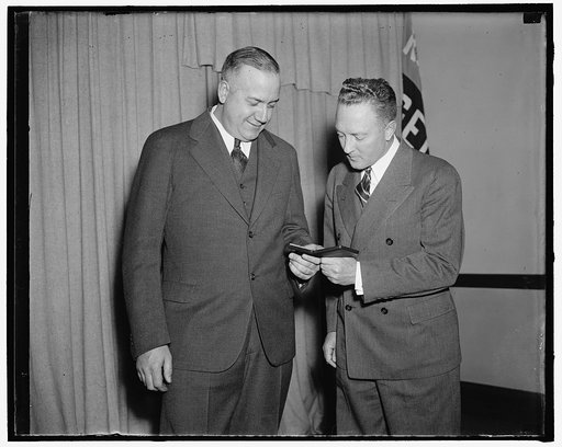 Admiral Byrd admires medal awarded to aide on Antarctic expedition. Washington, D.C., April 27. Rear Admiral Richard E. Byrd admires the gold medal of the National Geographic Society which was awarded today to Dr. Thomas C. Poulter, (left) senior scientist and second in command of the Byrd Antarctic