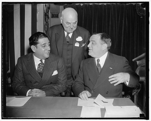 In spotlight at Mayors Conference Washington, D.C., Nov. 15. Mayor of Havana, Cuba, Antonio Beruff Mendieta (left) was welcomed to the Mayors Conference in the Capitol today be Fiorello La Guardia, (right) mayor of New York and president of the U.S. Conference of Mayors, and Mayor Angelo J. Rossi of