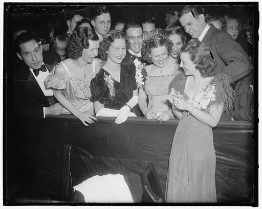 Besieged by autograph seekers. Washington, D.C., Jan. 29. Janet Gaynor, screen star was besieged by autographed seekers as she arrived to entertain the merrymakers at the president's birthday ball at the Wardman Park Hotel tonight, 1/29/38