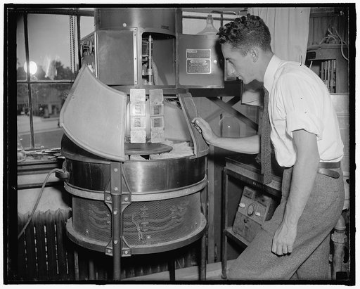 Government discovers method to preserve [...] (3) Test for fading. D. Levinsky of the Bureau of Standards is pictured exposing a developed film to light from a carbon arc to find whether the photographic image fades. The carbon-arc light simulates daylight closely and therefore is used for many mate