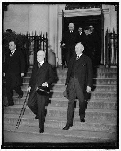 Justices attend funeral services for deceased Supreme Court Marshall. Washington, D.C., April 28. Chief Justice Charles Evans Hughes and Associate Justice James Clark McReynolds leaving Holy Trinity Catholic Church today after attending funeral services for the late Frank Key Green, marshal of the U