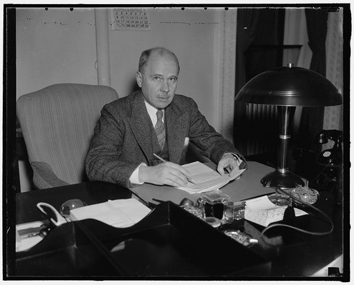 New Ambassador to Germany. Washington, D.C., Jan. 14. Hugh Wilson, former asst. sec. of State, and newly appoint ambassador to Germany replacing William E. Dodd, photographed at his desk at the State Department, 1/14/38