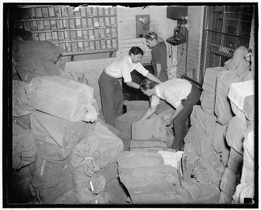 Ready for postman. Washington, D.C., Oct. 7. After they are printed and folded for mailing at the Government Printing Office, the unemployment census questionaires are dumped into a mail chute which carries them direct to the Washington City Post Office. Working on a 24 hour schedule, the G.P.O. is 