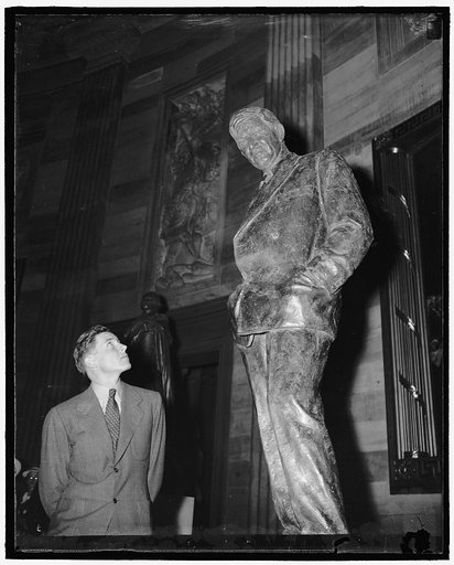 Visitor views the statue of humorist Will Rogers in the Rotunda of the U.S. Capitol