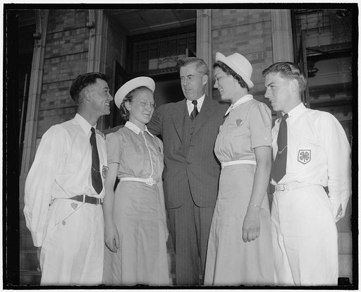 Henry A. Wallace, Secretary of Agriculture, center, with members of the 4-H club