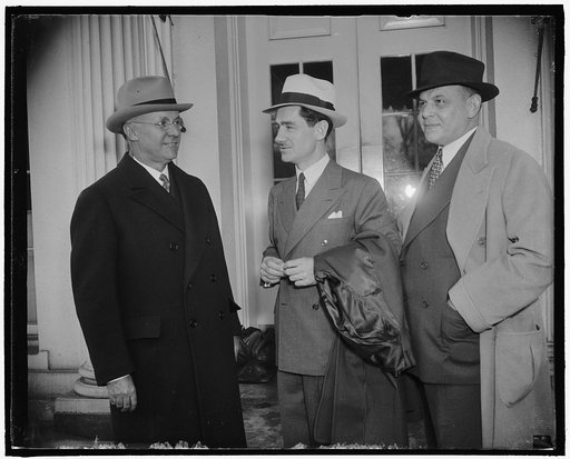 Mason Brittore[?], left, Lowell Thomas & George M. Sloceem[?], rt., at White House