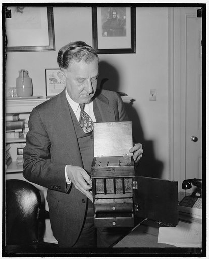 White House Secretary and medicine cabinet taken from White House in 1812. Washington, D.C., April 26. Stephen Early, Secretary to President Roosevelt with a mahogany brass bound medicine chest which was taken from the White House by a British sailor during the War of 1812 and returned yesterday by 