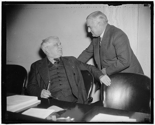Pennsylvania Senators. Washington, D.C., Mar. 14. Apparently unworried by the incoming elections, Senators James J. Davis, R. of Penna., seated, jokes with Joseph Guefey, D. of Penna. while attending the first executive meeting of the Senate Finance Committee today