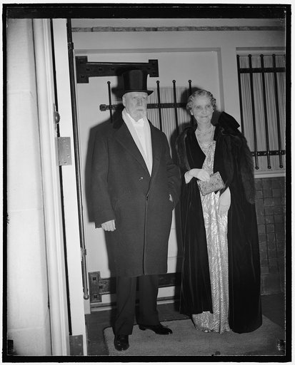 Chief Justice and Mrs. Hughes going to president's dinner and reception. Washington, D.C., Jan. 19. Supreme Court Justice Charles Evans Hughes and Mrs. Hughes as they left to attend the president's dinner for members of the Supreme Court tonight
