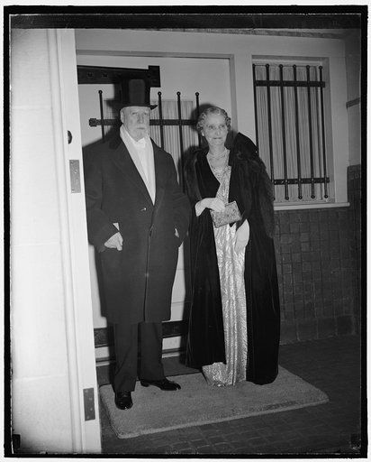 Chief Justice and Mrs. Hughes going to president's dinner and reception. Washington, D.C., Jan. 19. Supreme Court Justice Charles Evans Hughes and Mrs. Hughes as they left to attend the president's dinner for members of the Supreme Court tonight