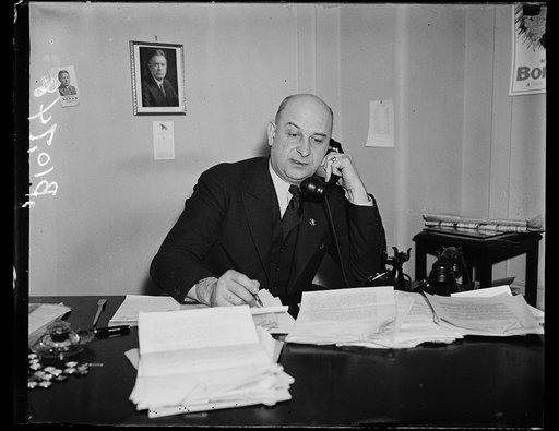 Carl Bachmann at desk with tel.