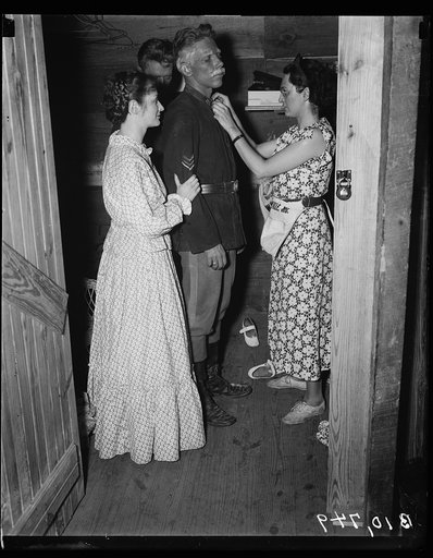Costume designer, Dorothy Croissant putting finishing touches to Hanison Libbey's uniform. Betty Gray looks on. Roadside Theatre
