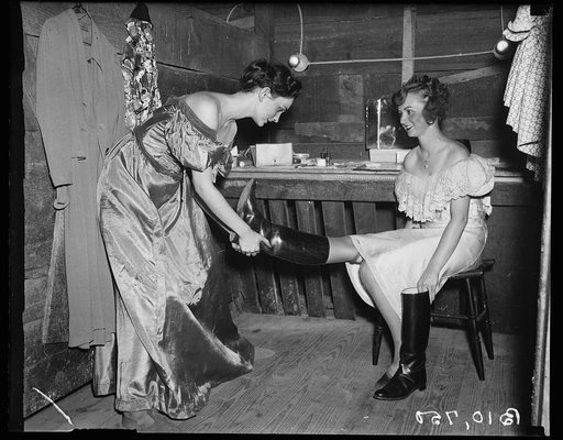 Izau Smith pulling off Lausive Hall's riding boot Roadside Theatre
