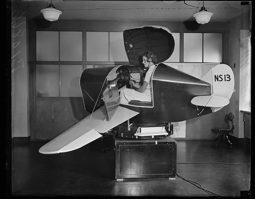 Floats thru the air. Washington, D.C. August 6. The links trainer for blind flying at the Department of Commerce takes the pilots on cross- country trips but never leaving the building. It flies and handles like an airplane picking up radio beacons on the course, banking and turning, does not know w