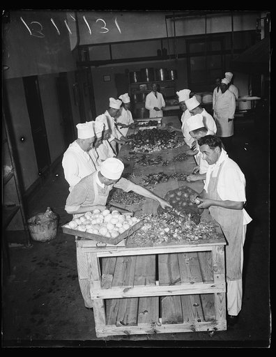 Washington, D.C. September 8. Mr. Tervay, Cost Accountant (at back) overlooking preparation of food for the banquet to be held in honor of the delegates to the Thrid World Power Conference which is being held here. The banquet is slated to be held next Thursday night at Union station here, and the n