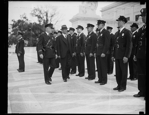 U.S. Supreme Court guard stand inspection, Washington, D.C. Oct. 1. The United States Supreme Court police force stood final inspection today on preparation for the convening of the high tribunal on next Monday. Marshal K. Green and Capt. P.H. Crook, Chief of the Guards are shown giving the boys the
