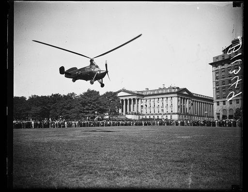 Autogiro lands near U.S. Treasury, Washington, D.C. Oct. 2. A new type autogiro thousands of city folks may be parking in the yards or on the roofs of apartment houses in is shown about to land near the U.S. Treasury. The ship was flown to Washington by James G. Ray, veteran autogiro pilot, for deli
