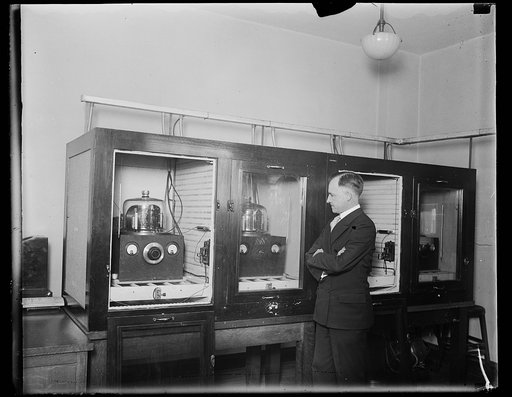 Man with a group of 100 kHz quartz crystal oscillators which served as the U.S. National primary frequency standard in 1929