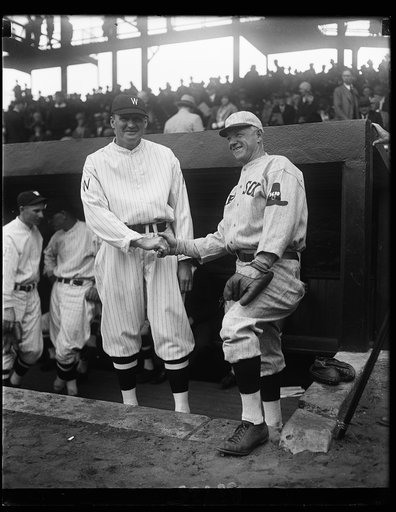Washington and Boston open baseball season in Washington. Heinie Wagner, manager of the Boston Red Sox, greets Walter Johnson, manager of the Washington Nationals, just before their teams clashed in the inaugural game of the 1930 baseball season in the Nation's Capital