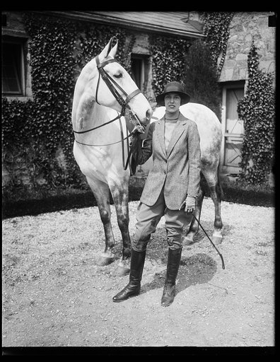 Daughter of Secretary of Commerce is ardent horsewoman. An ardent devotee of the bridal paths in the National Capital is Miss Gertrude Lamont, daughter of the Secretary of Commerce and Mrs. Robert P. Lamont, who is shown in this photograph with her favorite mount