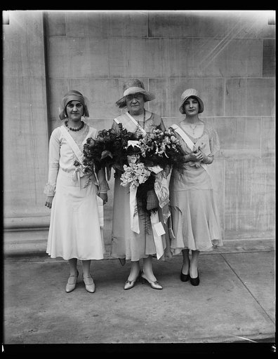 President General D.A.R. and personal pages. Mrs. Lowell Fletcher Hobart (center), President General of the Daughters of the American Revolution, photographed this morning at the opening of the 1930 meeting with her personal pages, Mrs. Mills Judy (left) daughter of Gov. Cooper of Ohio and Miss Lucy