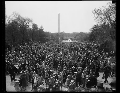 Washington children roll Easter eggs on White House lawn. Scene on the south lawn of the White House where today where thousands of Washington children rolled their Easter eggs. The Washington monuments can be seen in the background