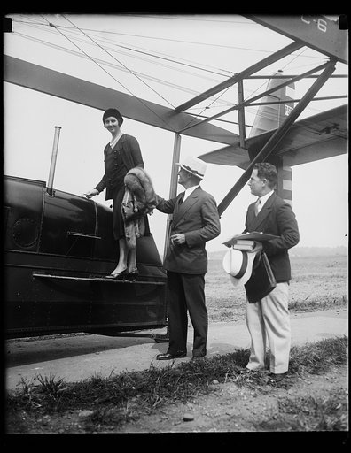 Fly to diplomatic post. Col. Hanford MaeNider, new American minister to Canada, and Mrs. MaeNider flew from Washington to Ottawa, where he will take up his diplomatic duties. The photograph shows Col. MaeNider assisting Mrs. MaeNider into the plane as they prepared to leave Bolling Field. They were 