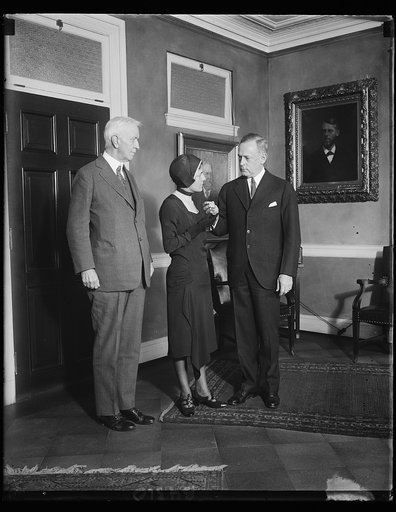 Widow of noted flyer receive medal. 12/13/30, Mrs. Florence Shaw Page receives the Distinguished Flying Cross awarded posthumously to the late Capt. Arthur H. Page, U.S. Marines, for this "pioneering" scientific [...] and successful accomplishment in the art of blind flying." The particular flight f