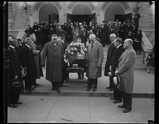 Labor leaders attend Mother Jones funeral. Men high in the ranks of labor circles took part in the last rites for "Mother" Jones, 100 year-old labor crusader. Standing in the middle of the group of three at the right is William N. Doak, newly appointed Secretary of Labor. The casket is being borne f