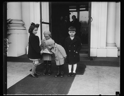 White House children receive greetings. Peggy Ann and Herbert Hoover, 3rd, received a message of Christmas greetings from the children of Washington. Kitty Murray and Harry G. Holme, Jr., both 6 years old, called at the White House and presented the message to the President's grandchildren. Left to 