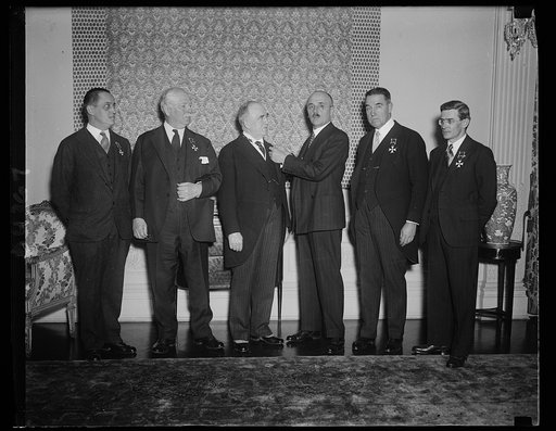 Five receive Polish decoration. Acting in behalf of the Polish government, Polish Ambassador Tytus Filipowicz presents the Officers' Cross of the Order of Polonia Restituta to five men who assisted in the celebration last year in honor of Count Casimir Pulaski, who played an important part in the Am