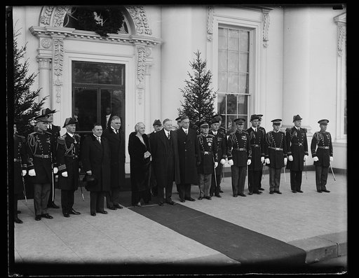 Presidential group at reception. The president and Mrs. Hoover photographed with the White House secretaries and military and naval aides, at the New Years reception. In the center of the group, left to right: Secretaries Lawrence Richey and George Akerson, President and Mrs. Hoover and Walter Newto