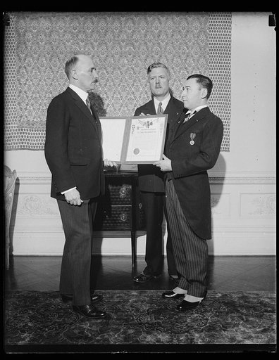 Men holding American Legion document or certificate